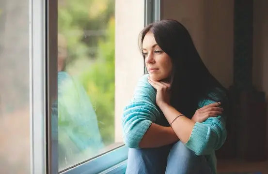 Woman Looking Out Window