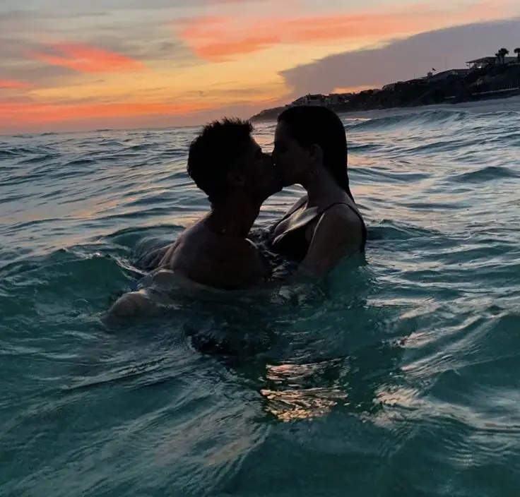 Couple in water at sunset