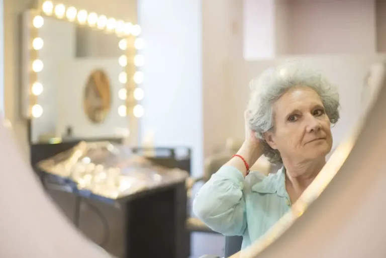 Mature Woman Looking at Herself in Mirror v2