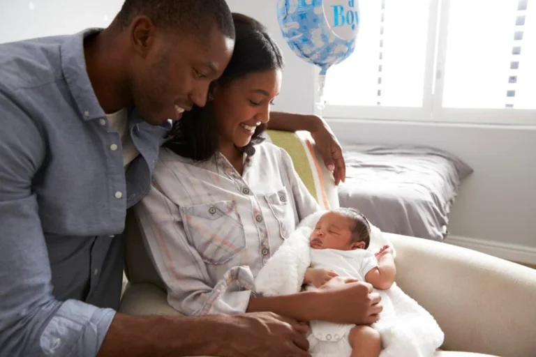 Parents-Home-from-Hospital-With-Newborn-Baby-In-Nursery
